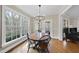Bright dining room with wood table, chandelier, and large windows overlooking trees at 2803 Cameron Pond Dr, Cary, NC 27519