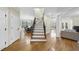 Spacious foyer with hardwood flooring, staircase, and views into the dining and living areas at 2803 Cameron Pond Dr, Cary, NC 27519