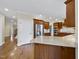 Bright kitchen with granite countertops, stainless steel refrigerator, and wood cabinets at 2803 Cameron Pond Dr, Cary, NC 27519
