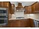 Gourmet kitchen featuring stainless steel appliances, custom cabinetry, and granite countertops at 2803 Cameron Pond Dr, Cary, NC 27519