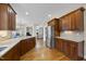 Open kitchen featuring custom cabinetry, granite countertops, and stainless steel appliances at 2803 Cameron Pond Dr, Cary, NC 27519