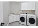 A well-organized laundry room featuring a sink, countertop space, cabinets, and modern appliances at 2803 Cameron Pond Dr, Cary, NC 27519