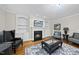 Cozy living room featuring a fireplace, built-in shelving and sophisticated decor at 2803 Cameron Pond Dr, Cary, NC 27519