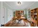 Well-lit home office with hardwood floors, a desk, and built-in bookshelves at 2803 Cameron Pond Dr, Cary, NC 27519