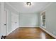 Versatile office room with hardwood floors, a large window, and closet space at 2803 Cameron Pond Dr, Cary, NC 27519
