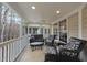 Relaxing screened porch with wicker furniture and ceiling fan, perfect for outdoor living at 2803 Cameron Pond Dr, Cary, NC 27519