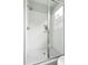 Modern bathroom with a glass-enclosed shower, hexagon tile floor, and white subway tile walls at 2816 Cascadilla St, Durham, NC 27704