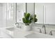 Bathroom with double sinks, modern fixtures, and quartz countertops at 2816 Cascadilla St, Durham, NC 27704