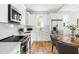Modern kitchen featuring stainless steel appliances, white cabinetry, and stone countertops at 2816 Cascadilla St, Durham, NC 27704