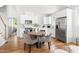Bright kitchen with stainless steel appliances, white cabinets, and a cozy dining area at 2816 Cascadilla St, Durham, NC 27704