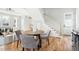 Open-concept living space with hardwood floors, modern lighting, and an adjacent kitchen at 2816 Cascadilla St, Durham, NC 27704