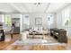 Bright living area featuring hardwood floors, modern furniture, and ample natural light, perfect for relaxation and entertainment at 2816 Cascadilla St, Durham, NC 27704