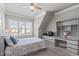 A well-lit bedroom features built-in shelving and a sloped ceiling at 2826 Walden Rd, Apex, NC 27502