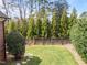 Landscaped backyard with mature trees, a stone walkway, and a well-maintained lawn at 3204 Cobblestone Ct, Raleigh, NC 27607