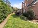 Expansive backyard featuring a stone walkway, a brick home exterior, and a lush lawn at 3204 Cobblestone Ct, Raleigh, NC 27607