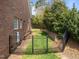 Fenced backyard offering privacy and security, complemented by mature greenery and home exterior at 3204 Cobblestone Ct, Raleigh, NC 27607