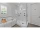 This bathroom features a seamless glass shower next to an inviting soaking tub at 3204 Cobblestone Ct, Raleigh, NC 27607