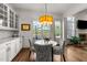 Bright dining area featuring a modern chandelier, hardwood floors and views of the fenced-in backyard at 3204 Cobblestone Ct, Raleigh, NC 27607