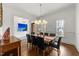 Bright dining room featuring hardwood floors, modern chandelier, and classic wainscoting at 3204 Cobblestone Ct, Raleigh, NC 27607