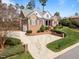 Beautiful brick home with manicured landscaping, a curved driveway, and inviting curb appeal at 3204 Cobblestone Ct, Raleigh, NC 27607