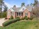 Stunning brick home with well-manicured lawn, blue shutters, and inviting front porch at 3204 Cobblestone Ct, Raleigh, NC 27607