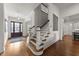 Grand foyer with hardwood floors, wooden staircase, and stylish decor creates an inviting entrance at 3204 Cobblestone Ct, Raleigh, NC 27607