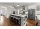 Open kitchen boasts a center island with seating and modern appliances for a chef's delight at 3204 Cobblestone Ct, Raleigh, NC 27607