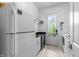 Bright laundry room with a large capacity washer and dryer near an exterior door at 3204 Cobblestone Ct, Raleigh, NC 27607
