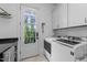 Laundry room featuring new large-capacity washer and dryer and access to the exterior at 3204 Cobblestone Ct, Raleigh, NC 27607