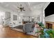 Spacious living room flowing into the kitchen, hardwood floors, and fireplace creating a cozy gathering space at 3204 Cobblestone Ct, Raleigh, NC 27607