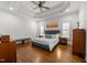 Serene main bedroom with tray ceiling, natural light, and hardwood floors at 3204 Cobblestone Ct, Raleigh, NC 27607