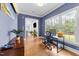 Bright office space featuring hardwood floors, a large window, and a view to an adjacent sitting room at 3204 Cobblestone Ct, Raleigh, NC 27607