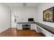 Well-lit office with built-in desk, drawers, cabinets, and sleek, dark countertop at 3204 Cobblestone Ct, Raleigh, NC 27607
