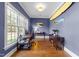 Home office featuring hardwood floors, natural light, and unique surfboard decor at 3204 Cobblestone Ct, Raleigh, NC 27607