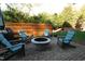 Outdoor patio area with a fire pit, comfortable chairs, and a wooden privacy fence at 3204 Cobblestone Ct, Raleigh, NC 27607