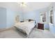 Light blue bedroom features a ceiling fan and a bright window with natural light at 3312 Clandon Park Dr, Raleigh, NC 27613