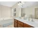 Bright bathroom features double sinks, soaking tub, and large mirror reflecting the spacious interior at 3609 Kilgo Dr, Durham, NC 27705