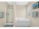 This bathroom includes a stand-up shower and large soaking tub below a window for lots of natural light at 3609 Kilgo Dr, Durham, NC 27705