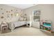 Cozy bedroom decorated with floral patterns, featuring a comfortable bed and ample natural light from the window at 3609 Kilgo Dr, Durham, NC 27705