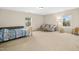 Spacious bonus room featuring a cozy couch, large windows, and carpet flooring, ideal for relaxation and entertainment at 3609 Kilgo Dr, Durham, NC 27705