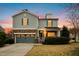 Charming two-story home featuring stone accents, a covered porch, and a well-manicured lawn at dusk at 3609 Kilgo Dr, Durham, NC 27705