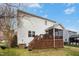 Back exterior view of the home featuring wood deck, lawn and blue flowerpots at 3609 Kilgo Dr, Durham, NC 27705