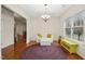 Bright living room featuring hardwood floors, a decorative chandelier, and a white couch at 3609 Kilgo Dr, Durham, NC 27705