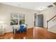 Bright living room with hardwood floors, large window, and views of the porch at 3609 Kilgo Dr, Durham, NC 27705