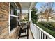 Cozy front porch with stone accents featuring a table, chairs, and white railings at 3609 Kilgo Dr, Durham, NC 27705