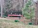 Landscaped backyard with a canoe and birdbath surrounded by daffodil flowers at 3609 Kilgo Dr, Durham, NC 27705