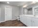 Bright bathroom with wood-look floors, double sink vanity, and ample storage at 38 Winter Red Way, Benson, NC 27504