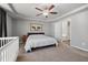 Bedroom with neutral carpet and paint, ceiling fan, and view of ensuite bath at 38 Winter Red Way, Benson, NC 27504