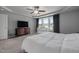 Bright bedroom featuring a ceiling fan, large window and a crib for the new baby at 38 Winter Red Way, Benson, NC 27504