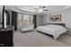 Neutral bedroom with a large bed, a ceiling fan, and a view of the backyard at 38 Winter Red Way, Benson, NC 27504